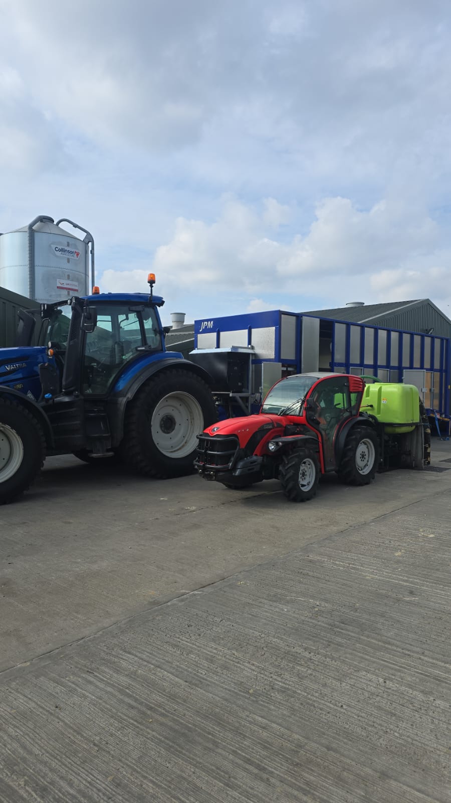Tractor and specialist disinfection sprayer parked in a farm yard